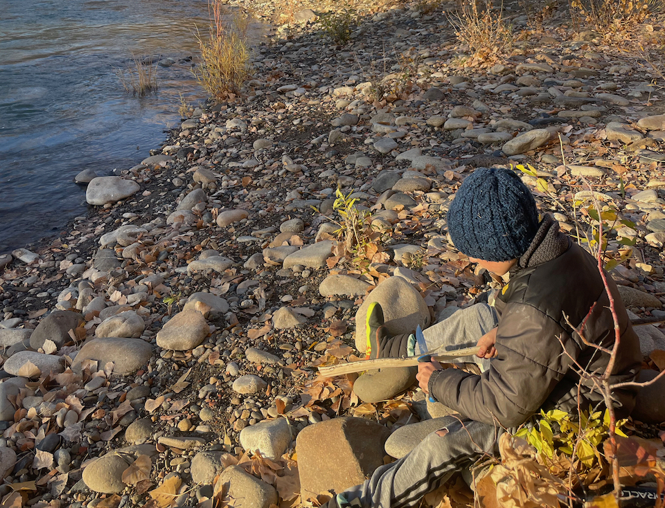 Whittling by the river