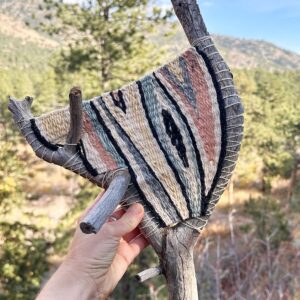 elaborate tapestry woven onto a forked branch