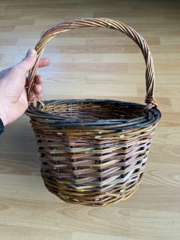 small round basket with black willow border